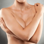Woman crossing arms over breast