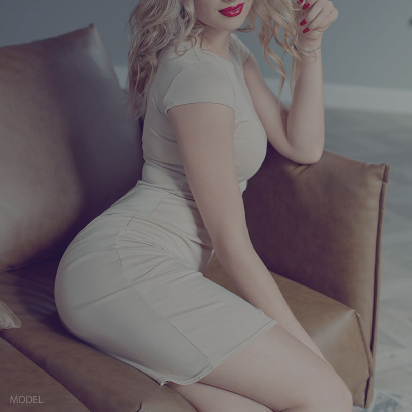 attractive blonde woman sitting in a chair