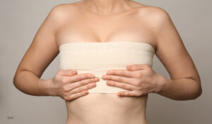 A woman's chest being wrapped in surgical dressing